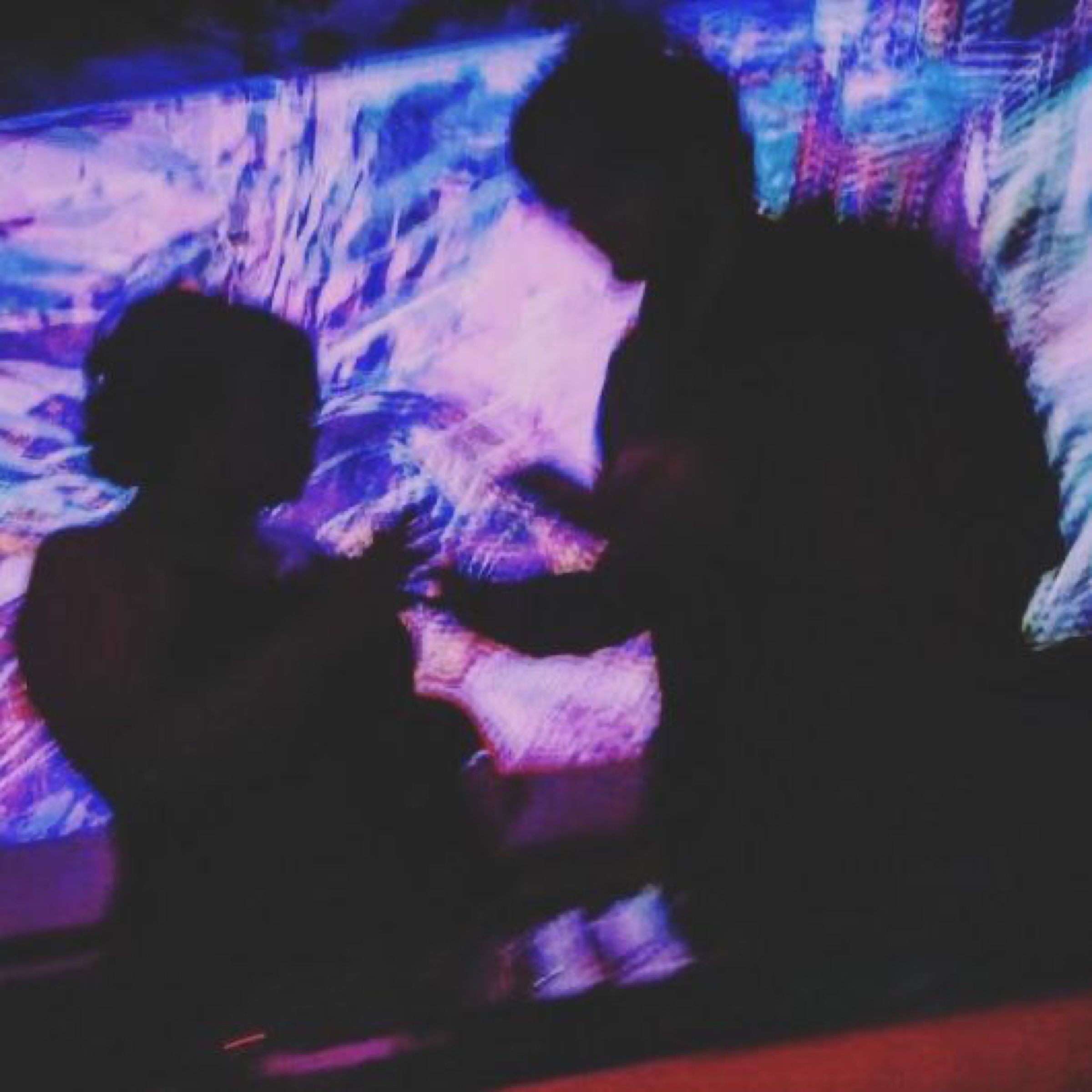 Rhea Fabian and Srinivas Vijayakumar silhouetted against projected purple and blue visuals during a Television Dust performance.
