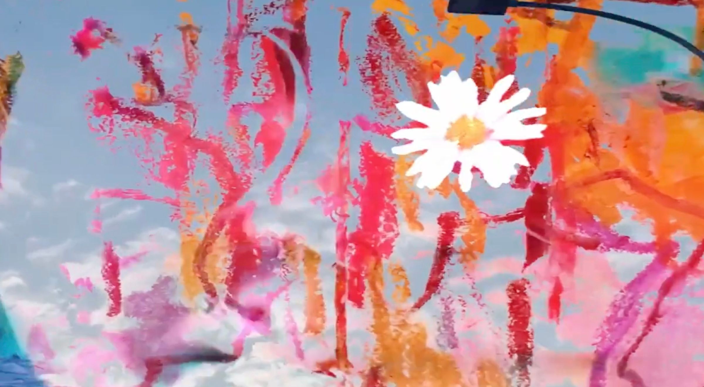 A white daisy overlaid with translucent pink and orange painted marks against a blue sky.