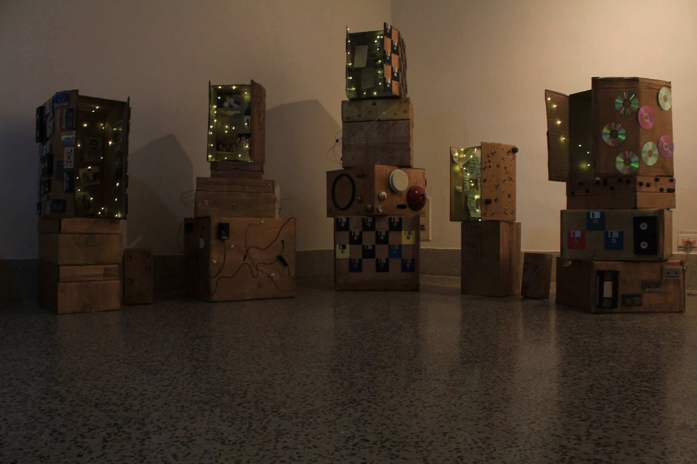 The complete Museum of Leftovers installation of illuminated cardboard structures decorated with discarded media.