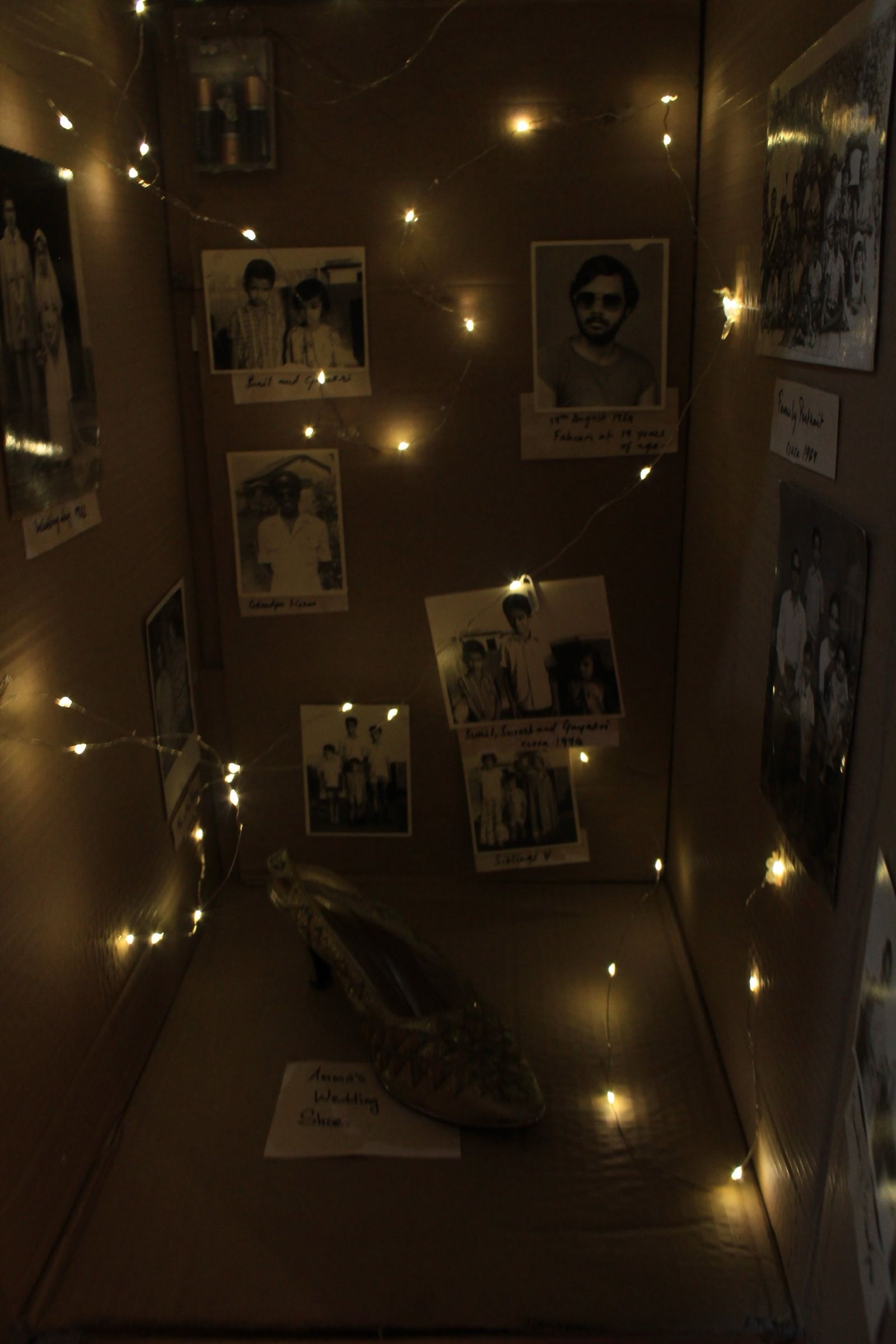 Five illuminated cardboard shrine structures decorated with cassettes, floppy disks and CDs.