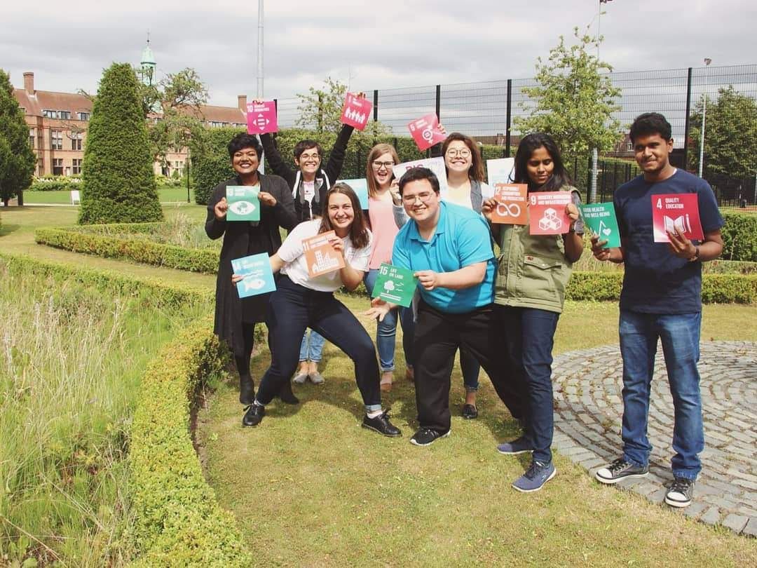 Young People and Revolution learning-track participants holding Sustainable Development Goal cards.