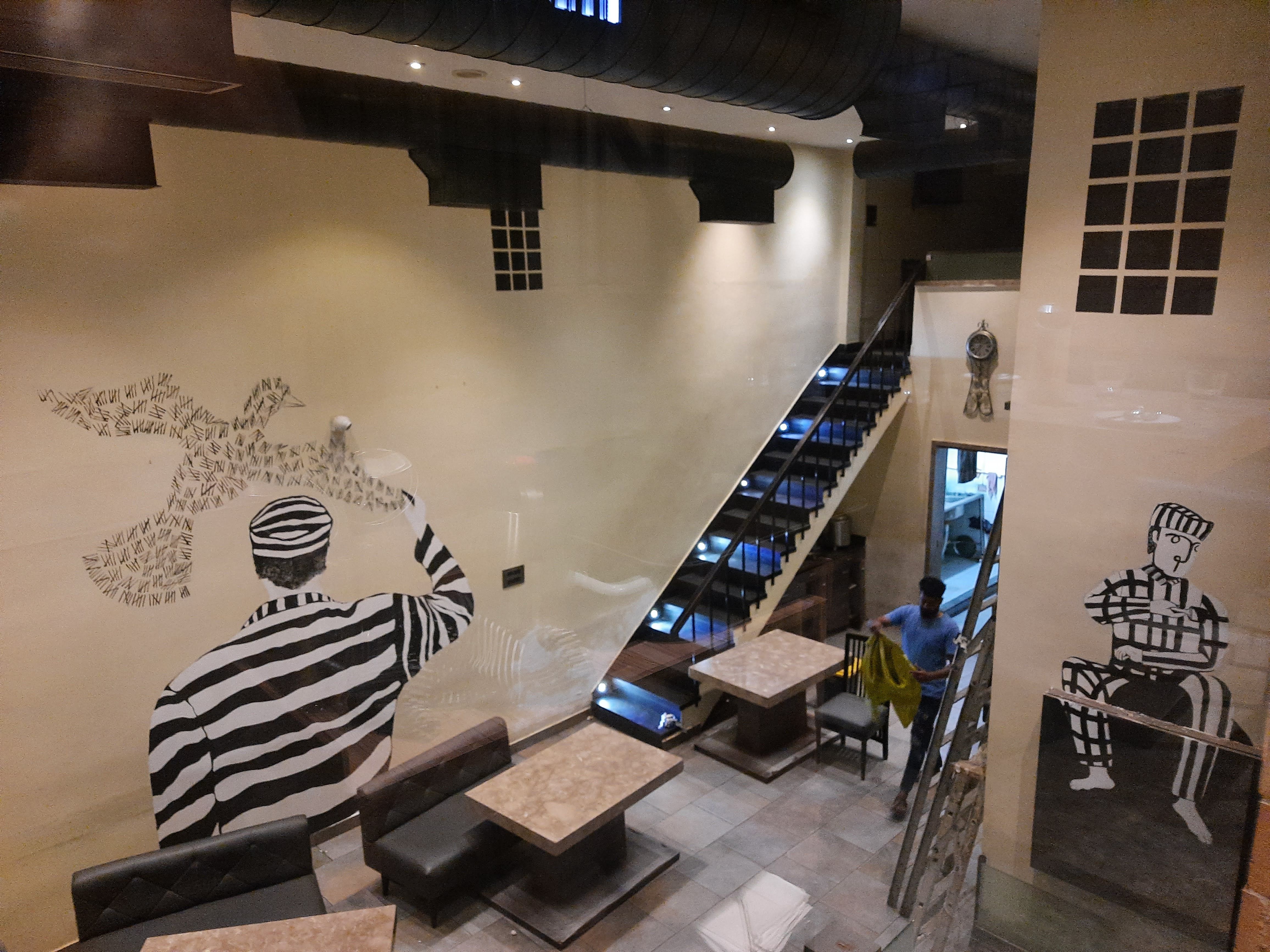 Institutional black-and-white figures integrated into the restaurant architecture.