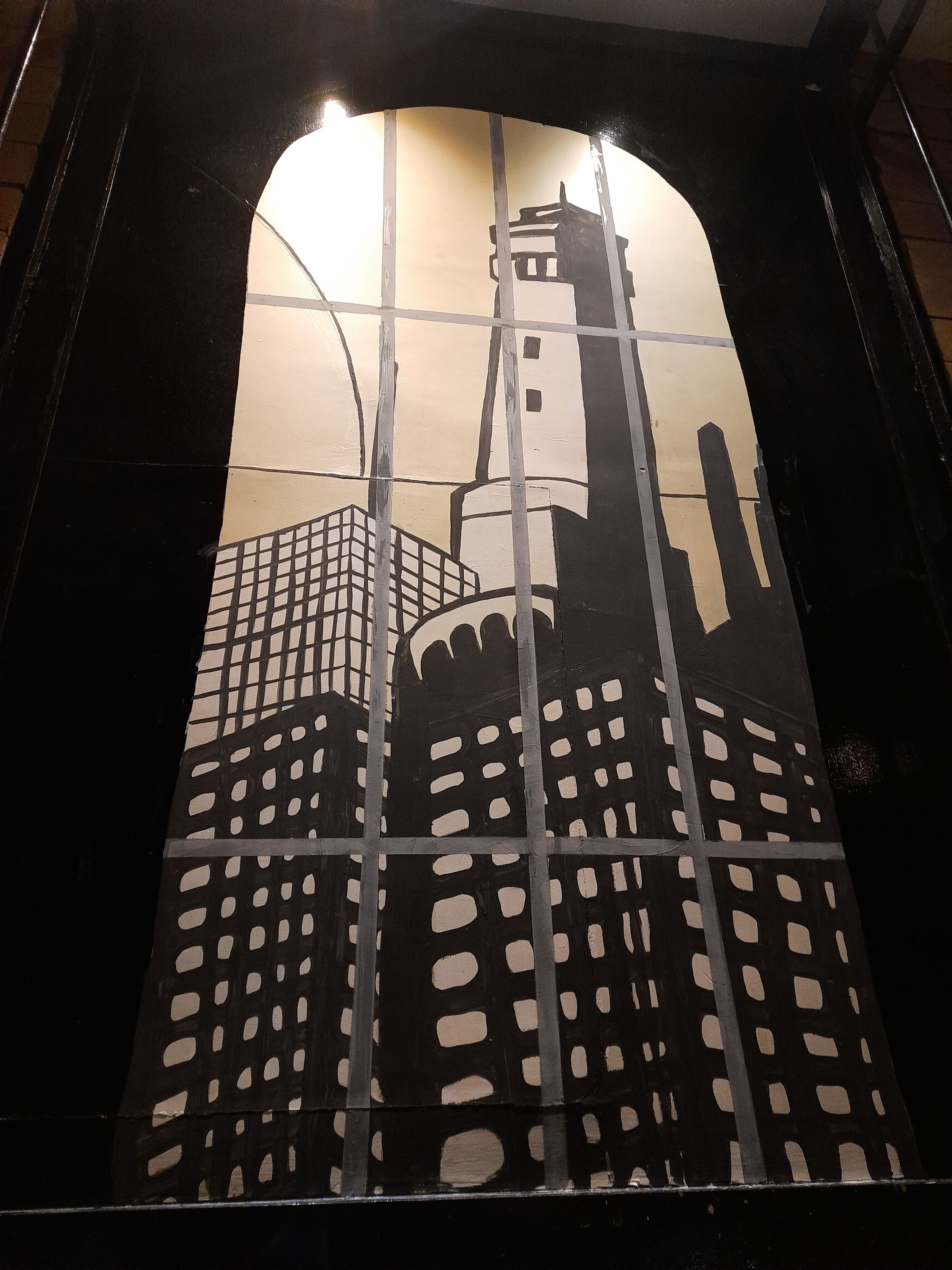 Prison-themed character murals painted around windows and interior walls.