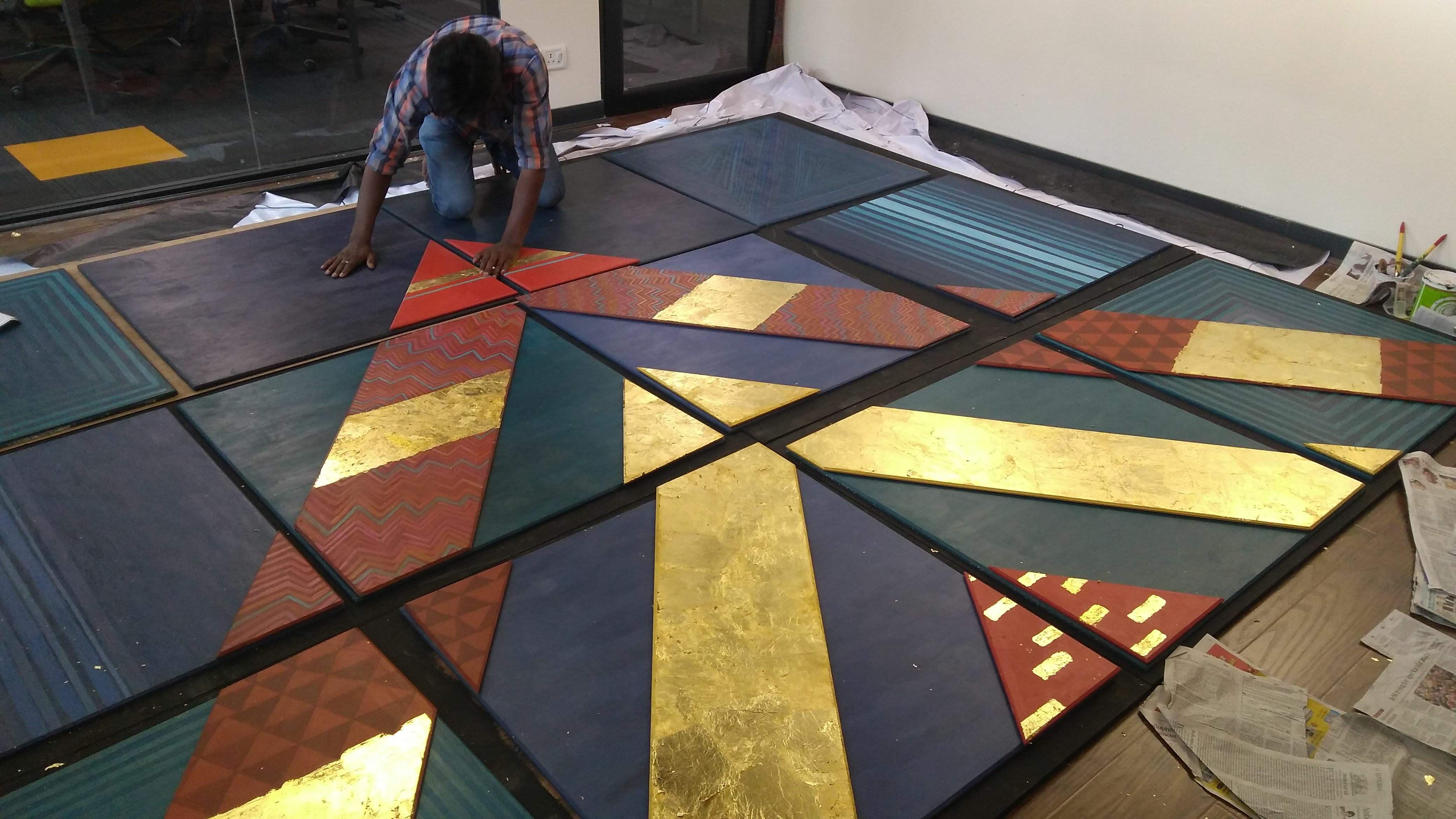 Sections of the geometric installation being assembled and painted.