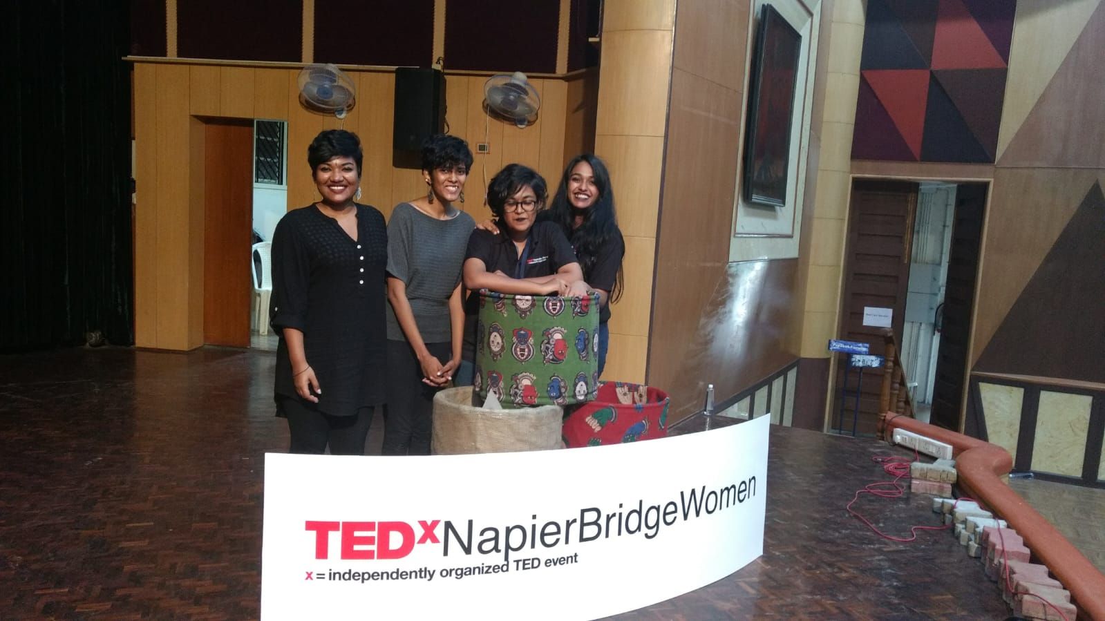 Members of the TEDxNapierBridgeWomen production team standing with the stage installation.