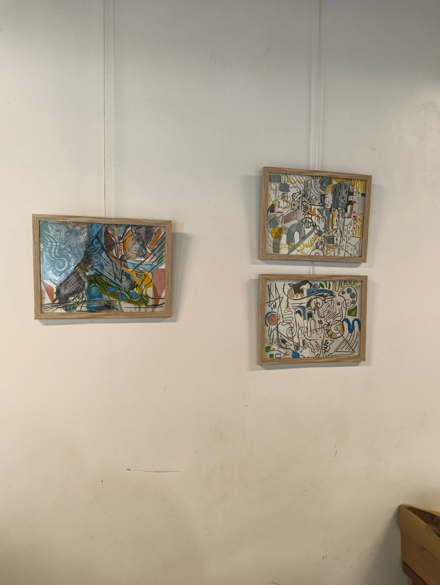 Three framed Human Music paintings arranged across a white gallery wall.